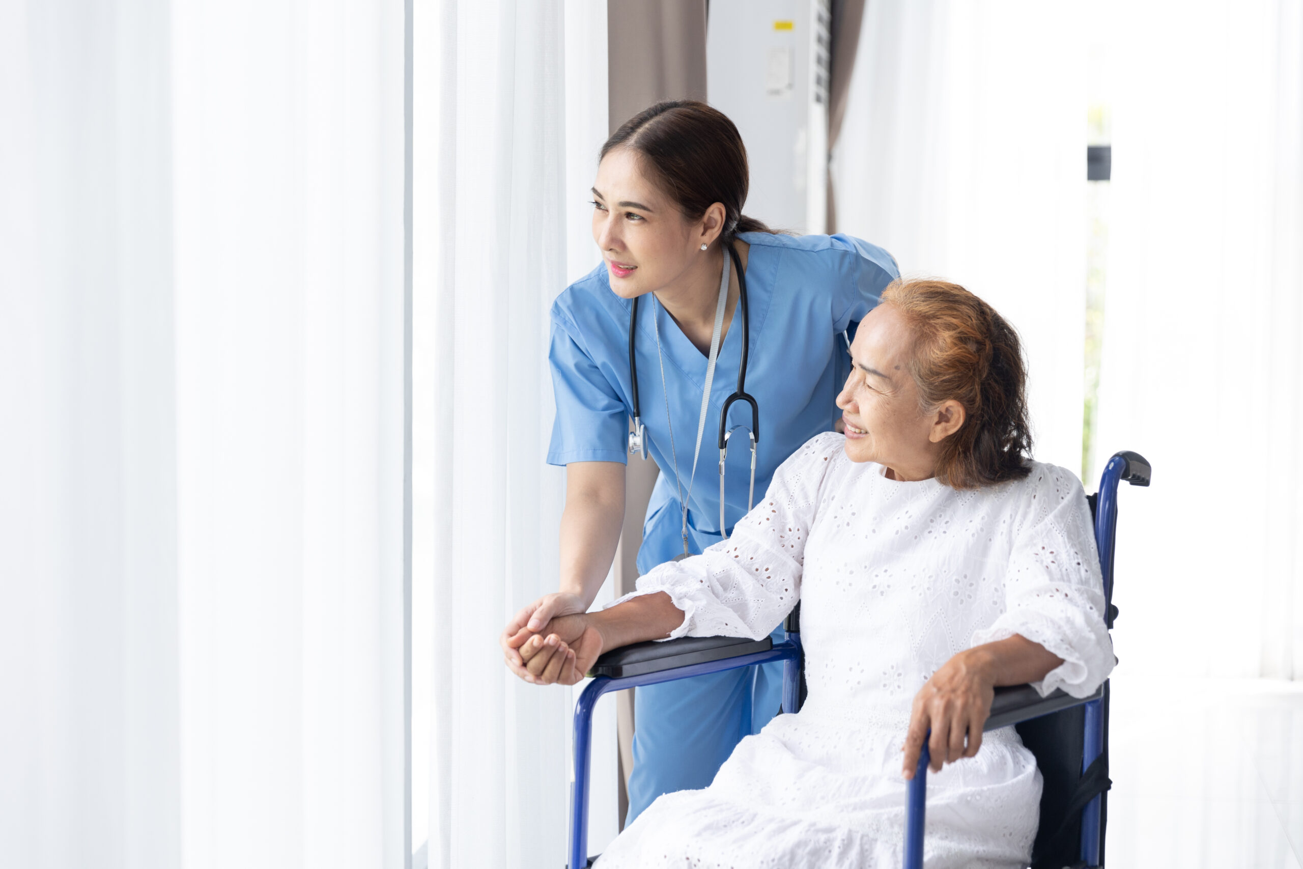 Travel nurse assisting elderly woman at home, providing care and support.