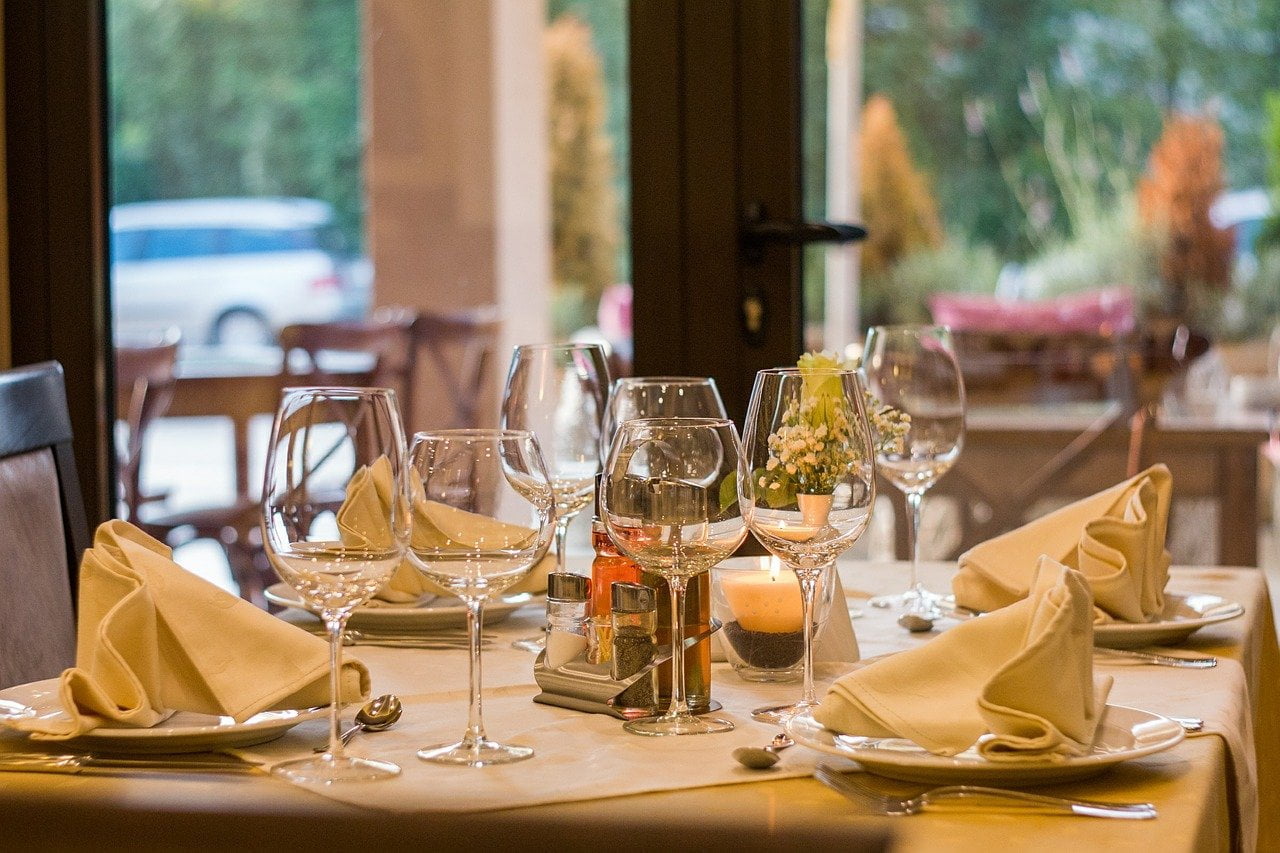 a table with wine glasses and food