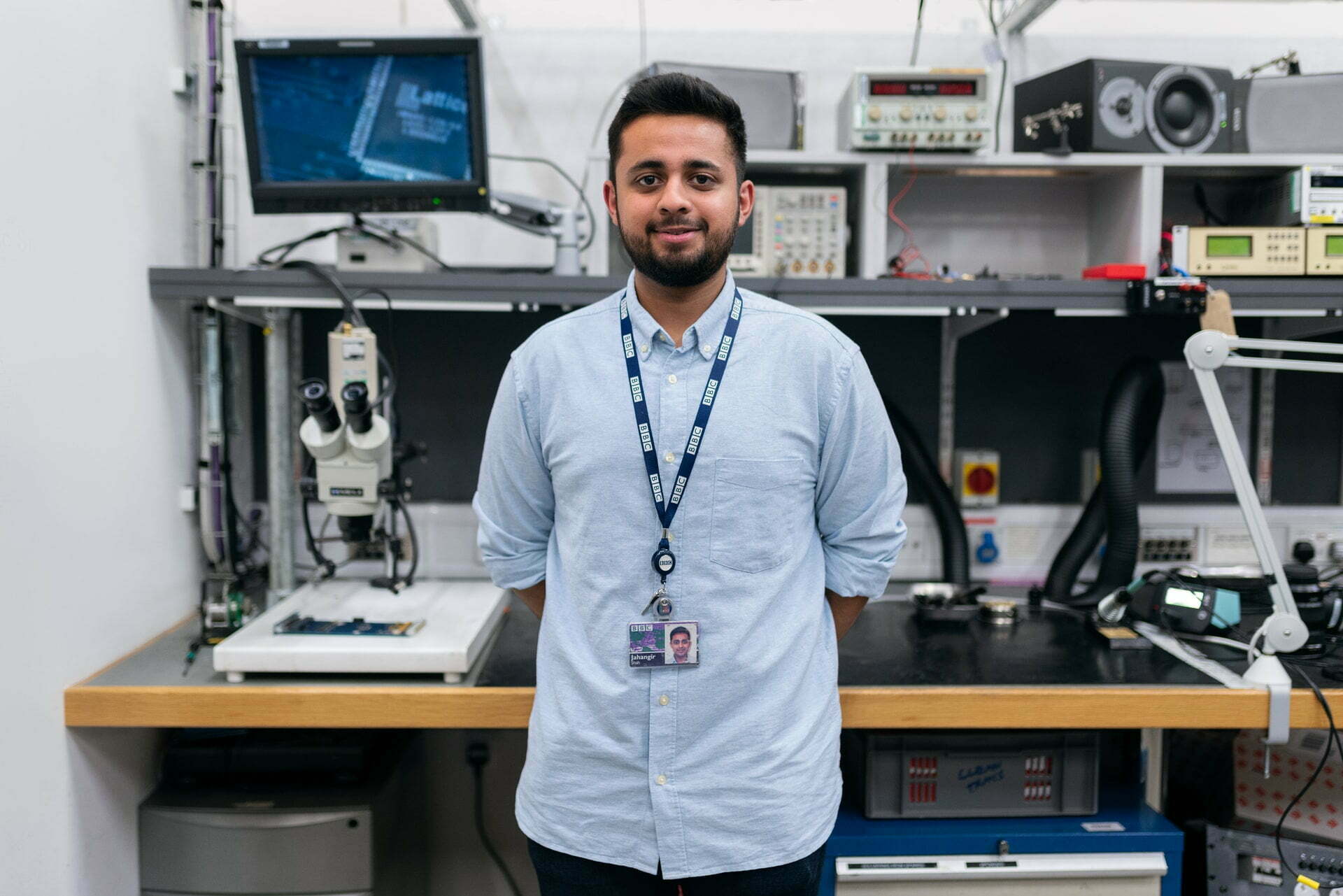 Azfar Jafri standing in front of a computer