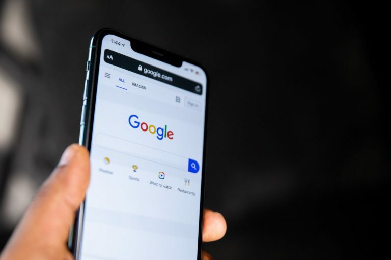 a hand holding a cell phone
