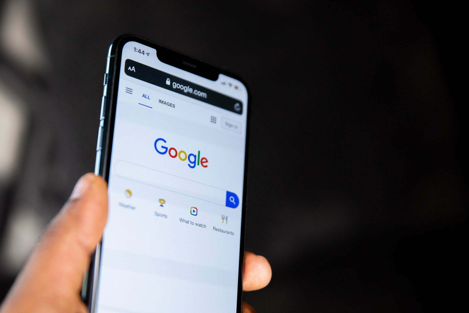 a hand holding a cell phone