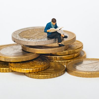 a person sitting on a pile of coins