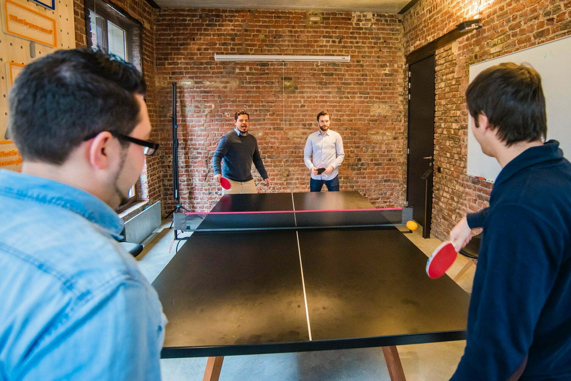 a group of men playing ping pong