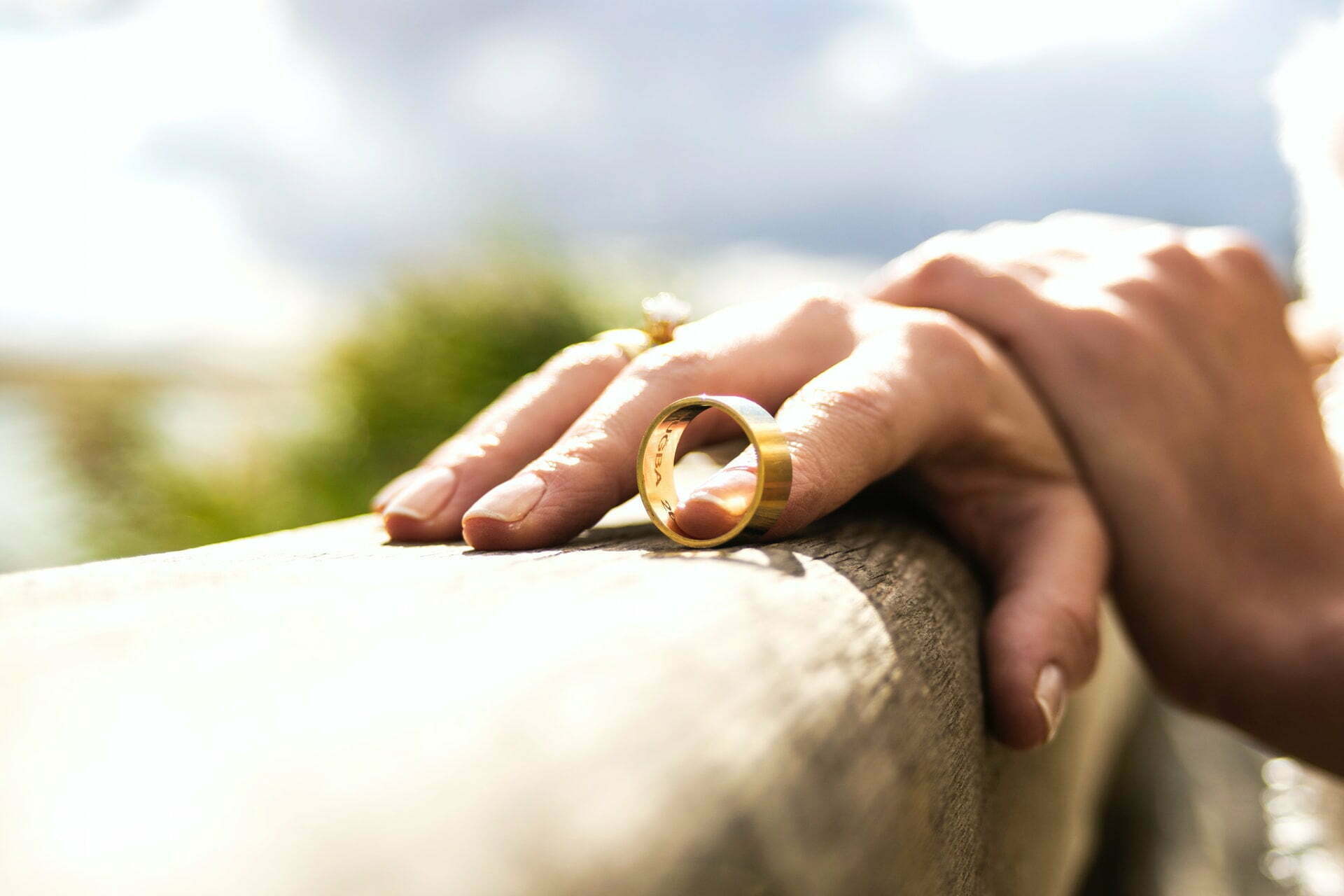 a person holding a small gold ring