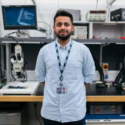 Azfar Jafri standing in front of a computer