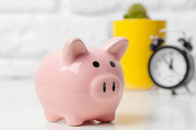 a pink piggy bank with a yellow cup and a green cup