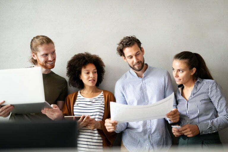 a group of people looking at a laptop