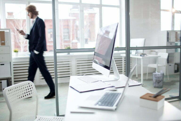 a person walking past a laptop