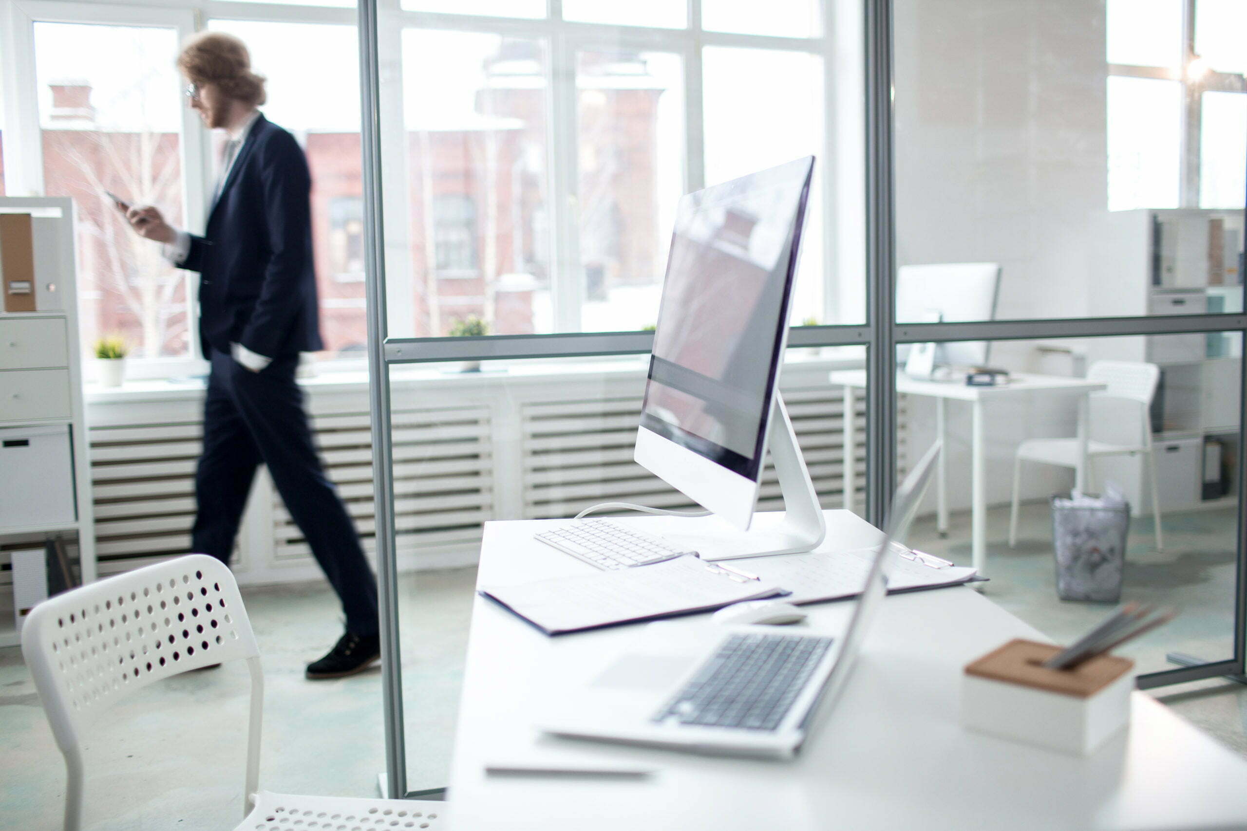 a person walking past a laptop