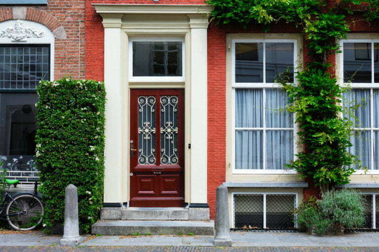 a red and white house with a black door