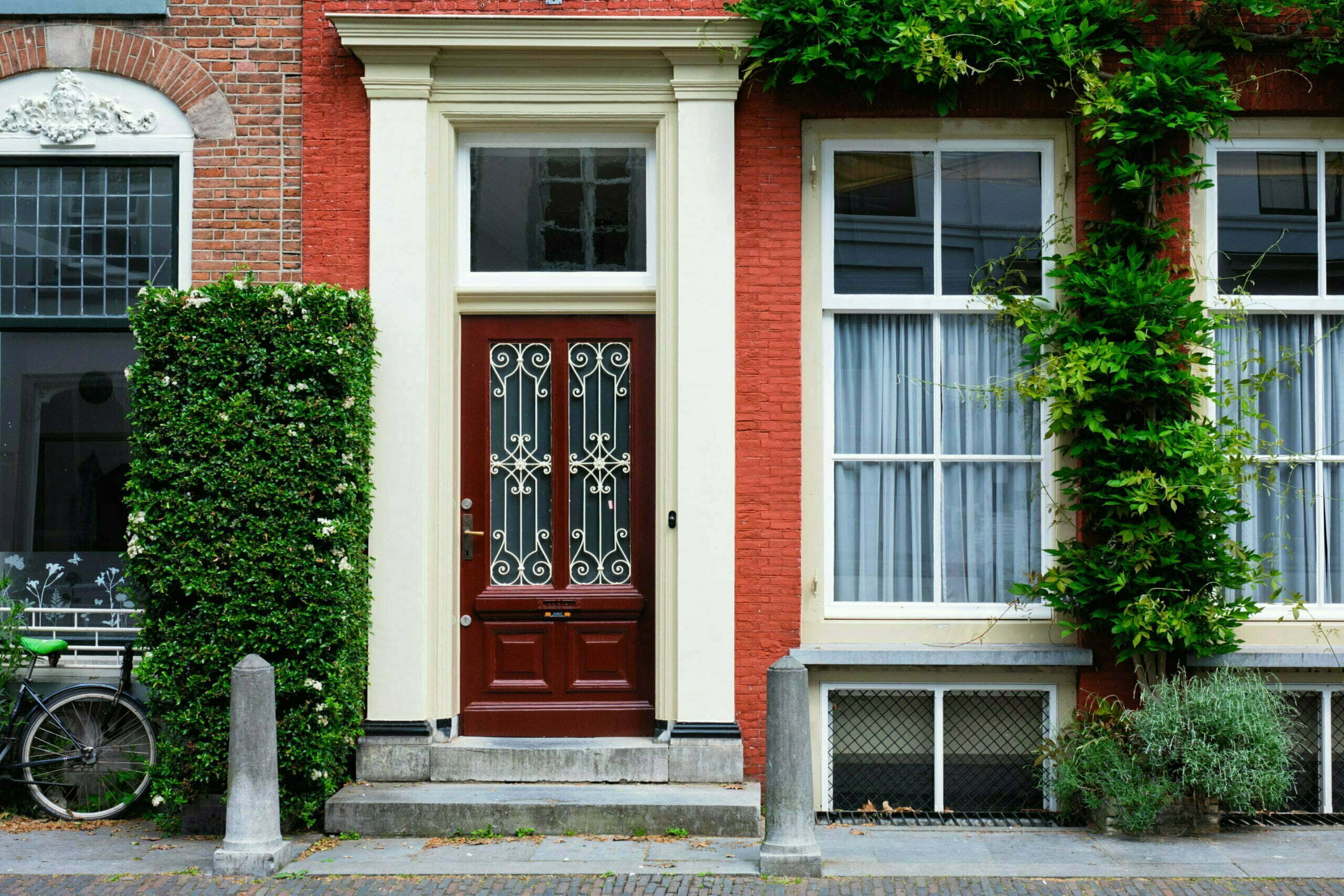 a red and white house with a black door